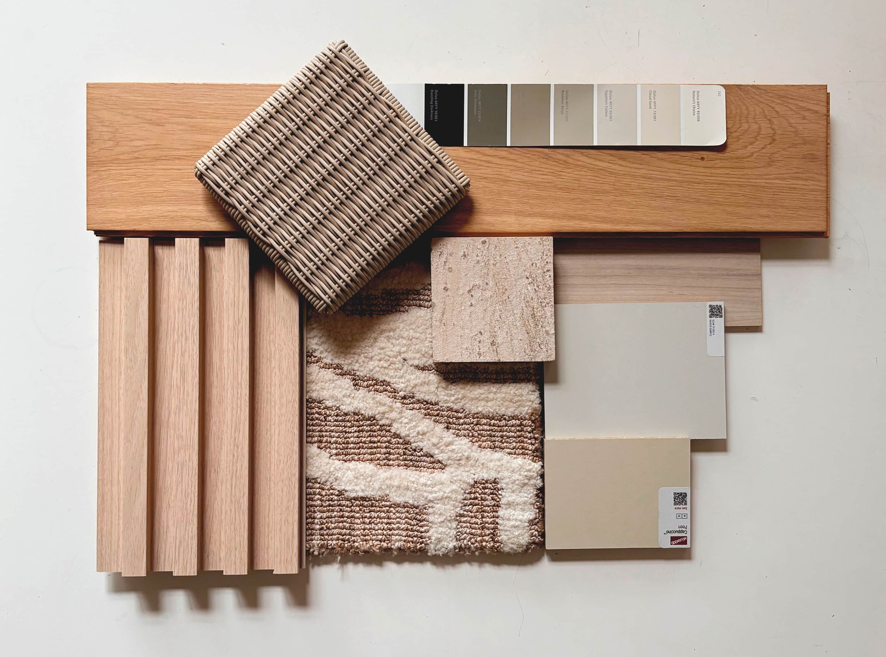 Material sample board with oak slats, woven fabric, travertine, a textured rug and paint swatches